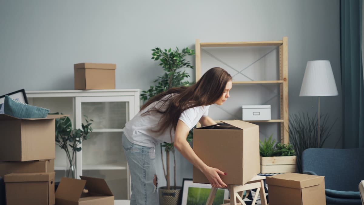 Packing boxes before a move, labelled by room