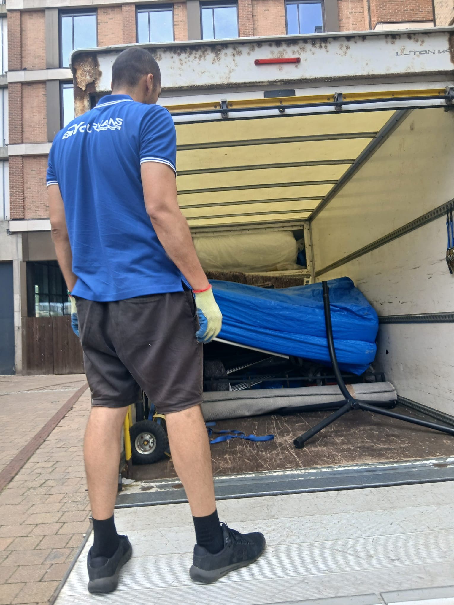 YourVans crew working from the tail lift, load wrapped and strapped